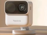 an image of a small white camera sitting on top of a wooden table