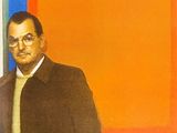 tableau représentant un homme debout devant un tableau aux couleurs orange, bleu et rouge