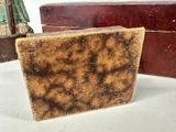 a soap bar sitting on a table next to a box