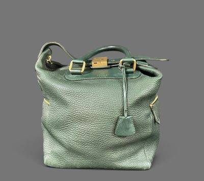 a green leather handbag with a gold buckle on the handle