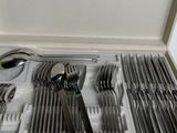 a box with a bunch of silverware in it