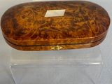 clear acrylic box with a wooden lid on a white surface