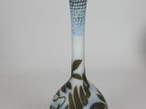 a glass vase that has a blue and white design on it