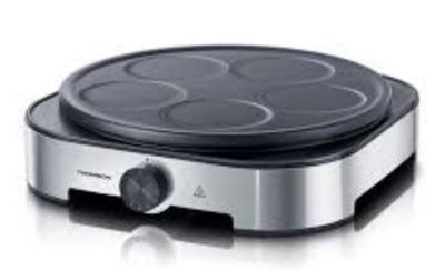 a close up of an electric griddle on a white surface