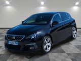 la voiture noire est garée sur un sol en damier dans le garage