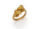 a close up of a gold ring on a white surface