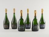 six bottles of champagne are lined up in a row