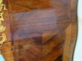 a wooden dresser with a marble top in a room