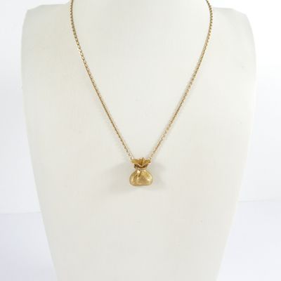 a gold plated necklace with a small glass bead on a gold chain