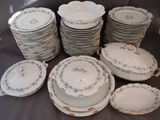 a lot of plates and bowls sitting on a table