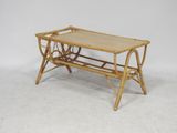 an old bamboo coffee table with a tray on top of it