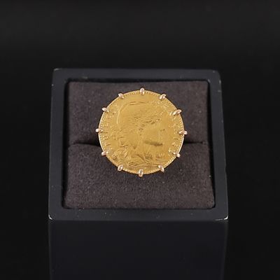 l'image d'une pièce d'or dans une boîte noire posée sur une surface noire
