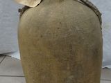 a large bottle that is sitting on a tile floor