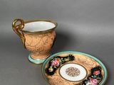 a cup and saucer sitting next to each other on a table