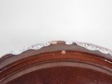 a close up of a brown plate with a white edge