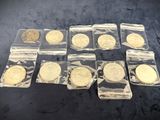 six different types of gold coins in plastic bags on a black surface