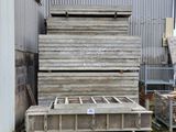 a large pile of wooden planks in front of a building