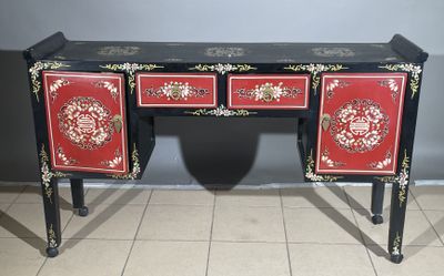 a red and black desk with two drawers on it