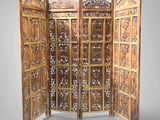 an image of a room divider made of wood with intricate carvings