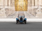 a blue car that is parked in front of a building
