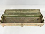 an old metal box with a lid on a white surface
