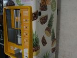 a vending machine with pineapples on the side of it