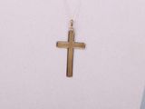 a close up of a necklace with a cross on a mannequin