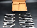 a lot of forks and spoons in a case