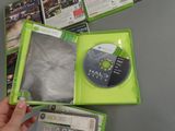 someone is holding a video game in a green case