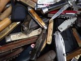 many different types of knives and knives in a pile