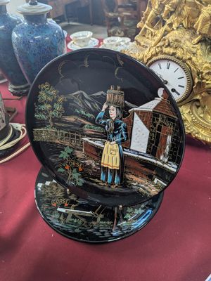 a plate with a picture of a woman on it on a table