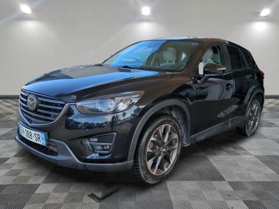 a black mazda cx - 5 parked on a checkered floor