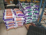 many bags of cement on a pallet in a warehouse