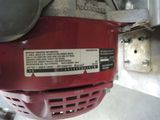 a close up of a red motor on a white surface