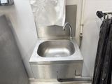 a stainless steel sink in a small room