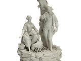 statue représentant un homme et une femme assis sur un rocher, accompagnés d'un chien