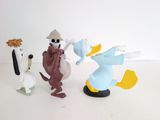 three figurines of goofy and pluto on a white surface