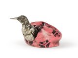 un oiseau perché sur un objet rose