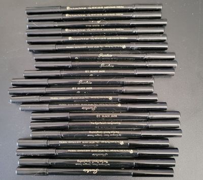 a lot of pens that are lined up on a table