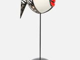 a close up of a bird on a stand with a white background