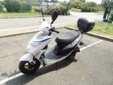 a scooter that is parked in a parking lot