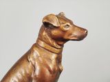 a statue of a dog that is sitting on a table
