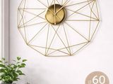 a clock that is on the wall next to a potted plant