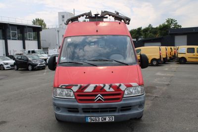 a red van that is parked in a parking lot