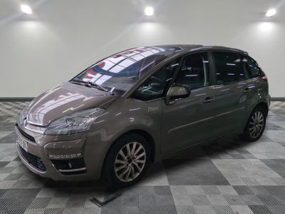 the small car is parked on the checkered floor in the garage