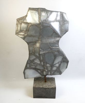 silver and black sculpture of a torso on a marble base