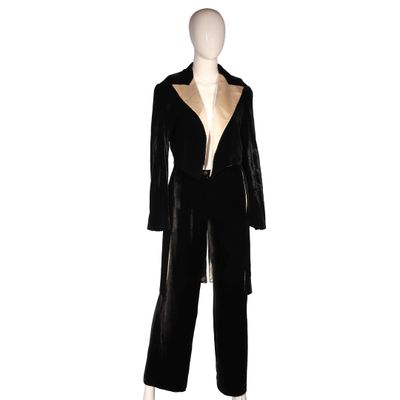 a mannequin wearing a black suit with gold trimmings
