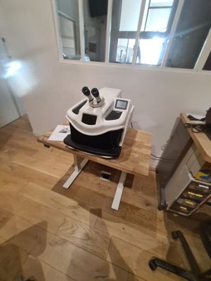 a machine that is sitting on top of a wooden table