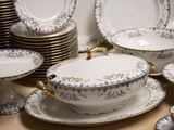 a lot of plates and bowls that are on the table