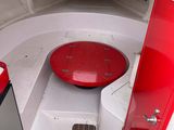 a red table in the center of a white boat